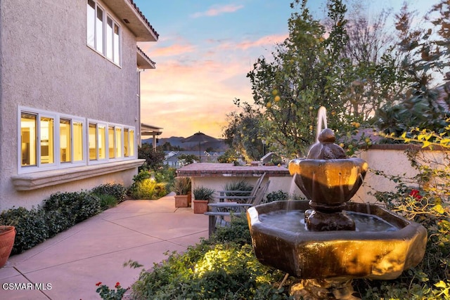 view of patio terrace at dusk