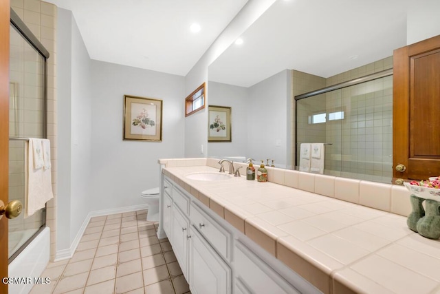 full bathroom featuring tile patterned flooring, vanity, enclosed tub / shower combo, and toilet