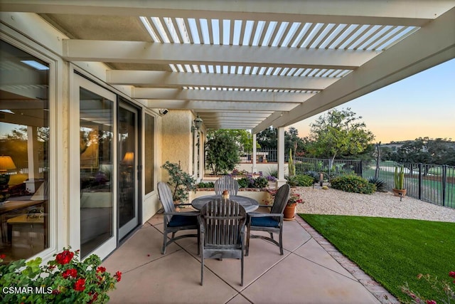 patio terrace at dusk with a yard and a pergola