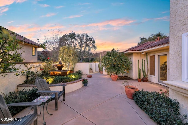 view of patio terrace at dusk