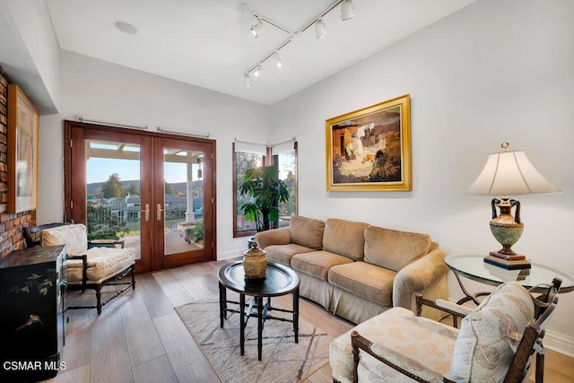 living room featuring french doors and light wood-type flooring