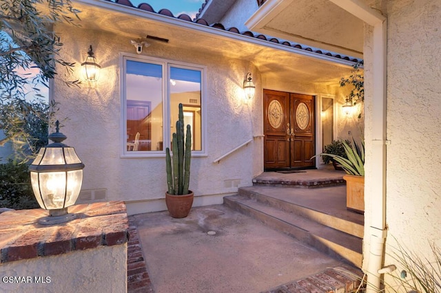 doorway to property with a patio area