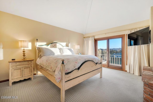 bedroom featuring light colored carpet, lofted ceiling, and access to exterior