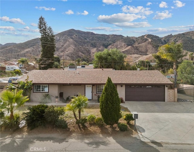 view of front of home with a mountain view and a garage