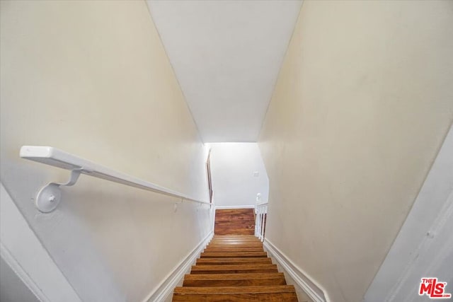 stairs featuring hardwood / wood-style flooring