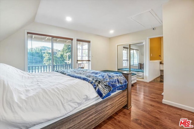 bedroom with wood-type flooring and lofted ceiling