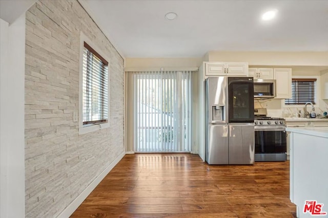 kitchen featuring sink, white cabinets, dark hardwood / wood-style flooring, and stainless steel appliances