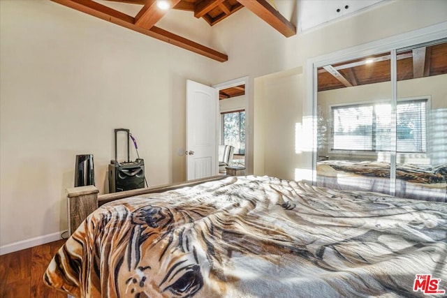 bedroom featuring wood-type flooring and lofted ceiling with beams