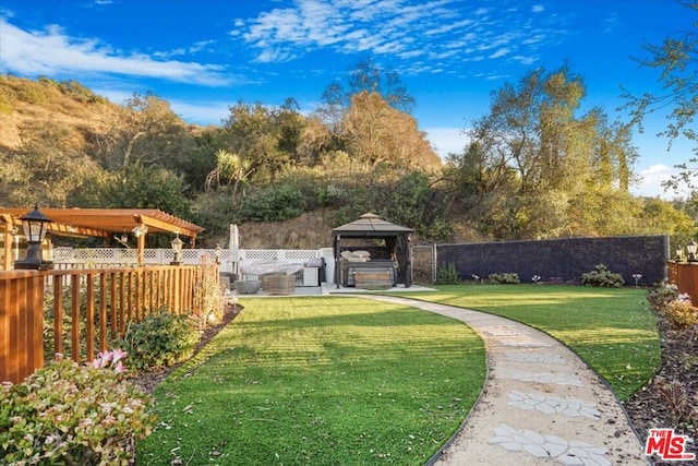 view of yard with a gazebo and a hot tub