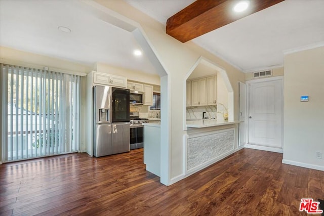 kitchen featuring beamed ceiling, appliances with stainless steel finishes, and dark hardwood / wood-style flooring