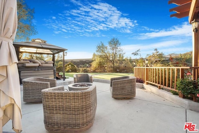 view of patio / terrace with an outdoor fire pit and a gazebo