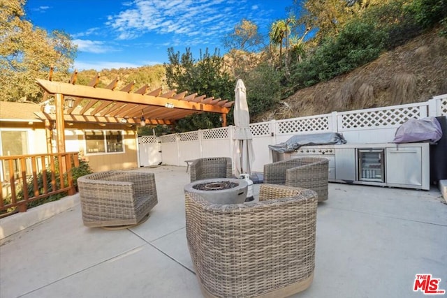 view of patio featuring area for grilling, a fire pit, and a pergola