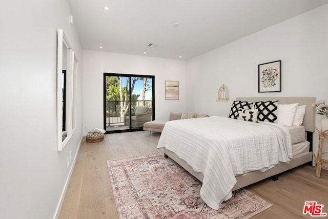 bedroom featuring light hardwood / wood-style floors and access to exterior