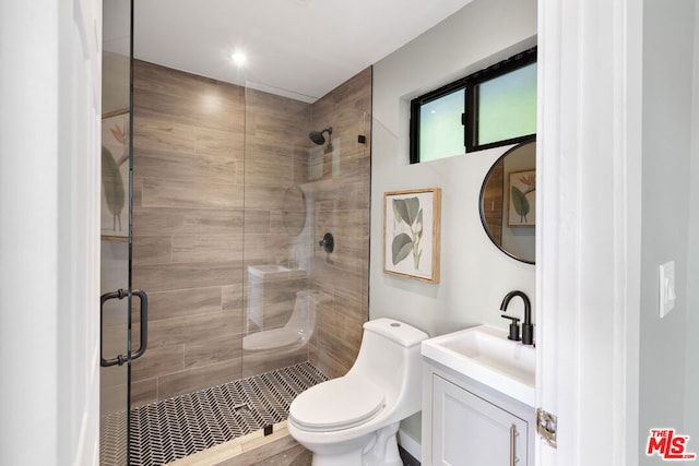 bathroom featuring vanity, toilet, and a shower with door