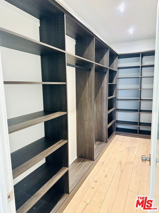 walk in closet featuring hardwood / wood-style flooring