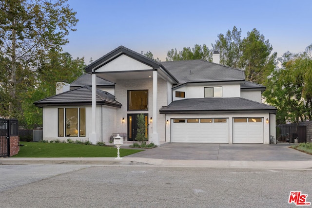 view of front of property featuring a garage and a front yard