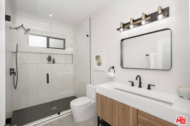 bathroom featuring a shower with shower door, toilet, and vanity