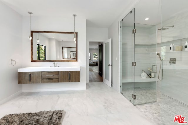 bathroom with walk in shower and vanity