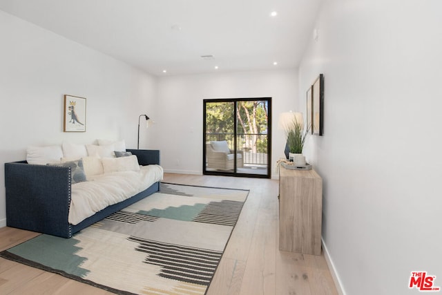 bedroom with hardwood / wood-style flooring and access to exterior