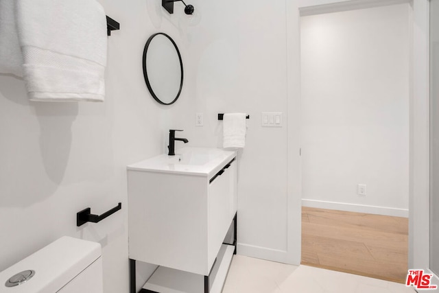 bathroom with toilet and vanity