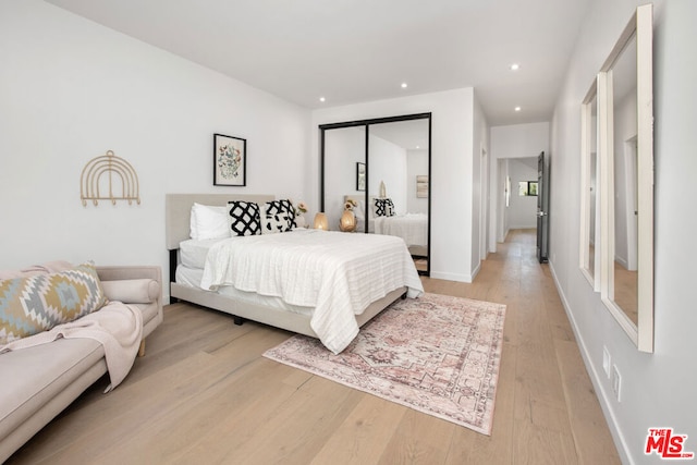 bedroom with a closet and light wood-type flooring