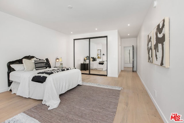 bedroom featuring a closet and light wood-type flooring