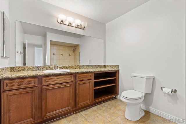 bathroom with toilet, vanity, and a shower