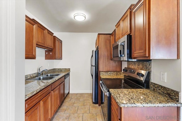 kitchen featuring sink, stainless steel appliances, and light stone countertops