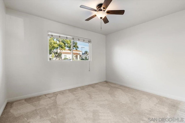 empty room with ceiling fan and light colored carpet