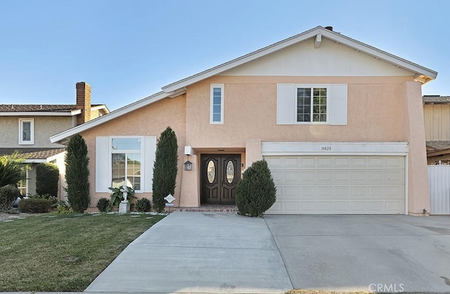 view of front of house with a garage and a front lawn