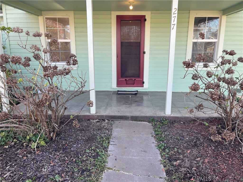 doorway to property with a porch