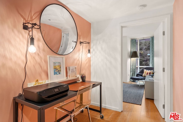 hallway with light hardwood / wood-style flooring