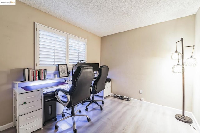 office with hardwood / wood-style flooring and a textured ceiling