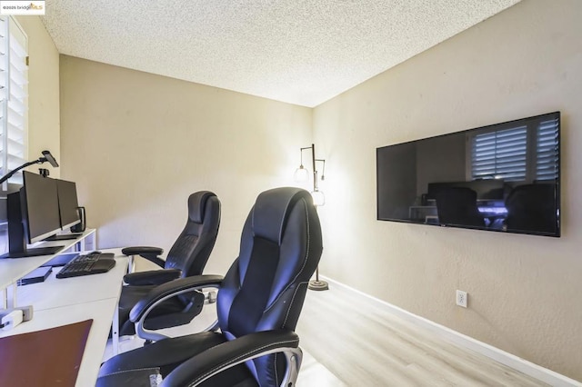 home office with hardwood / wood-style flooring and a textured ceiling