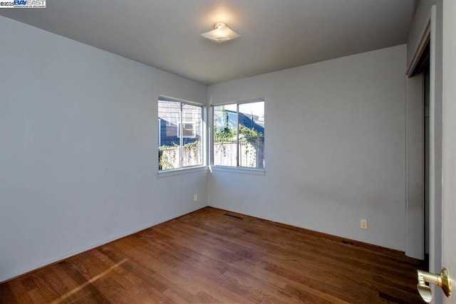 empty room featuring dark wood-type flooring