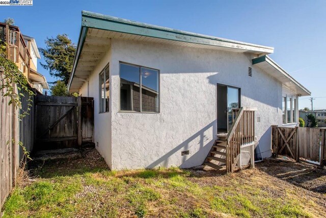 rear view of property with a lawn