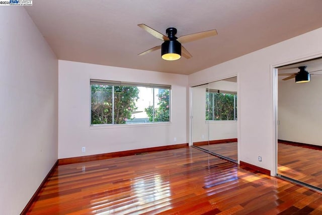 spare room with hardwood / wood-style flooring and ceiling fan