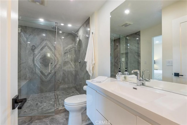 bathroom with vanity, toilet, and an enclosed shower