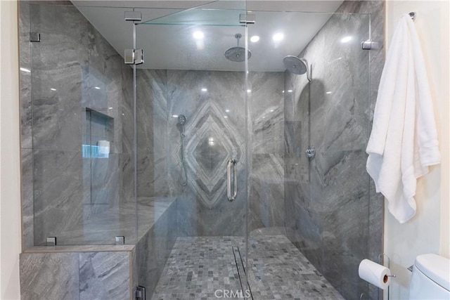 bathroom with toilet and walk in shower