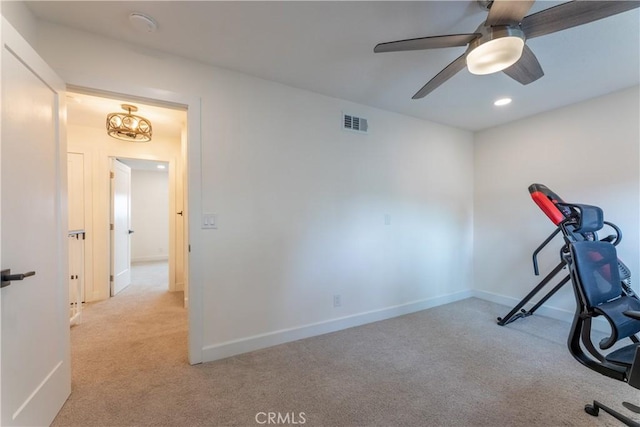 workout area featuring ceiling fan and light colored carpet