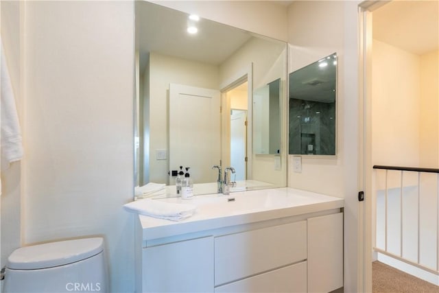 bathroom with toilet and vanity