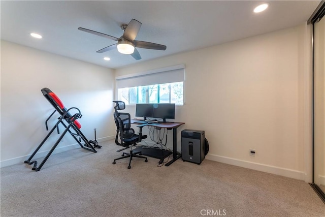 carpeted home office featuring ceiling fan