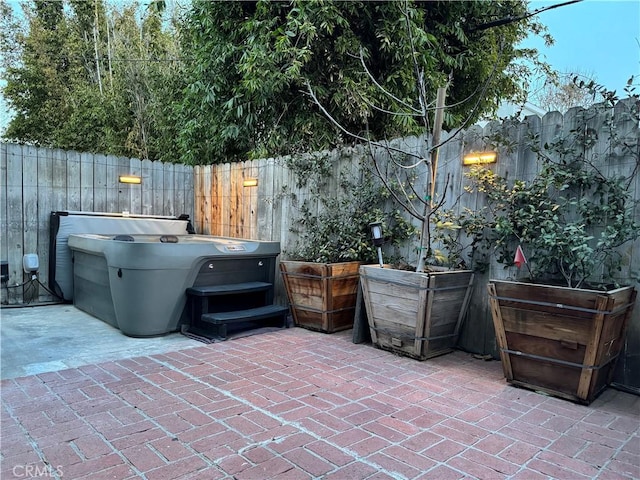 view of patio / terrace with a hot tub