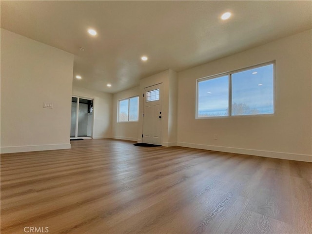 interior space with light hardwood / wood-style floors and a wealth of natural light