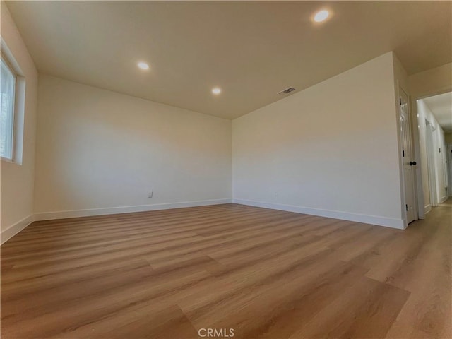 empty room with light hardwood / wood-style floors