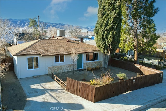 rear view of house featuring a mountain view