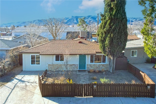 view of front of home with central air condition unit and a mountain view