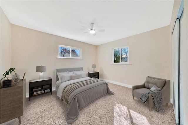 carpeted bedroom featuring baseboards and a ceiling fan