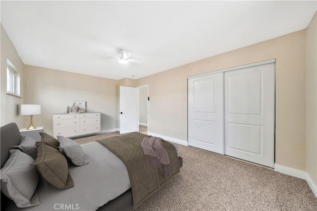 bedroom with baseboards, carpet, a closet, and a ceiling fan