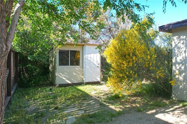 view of shed featuring fence